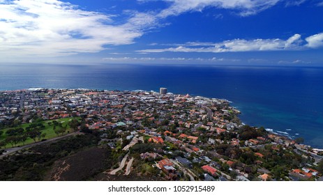 Aerial view of downtown La Jolla and beautiful shallow depths of the Pacific Ocean with clouds reflecting on the water surface