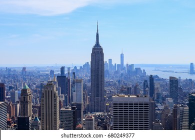 Aerial view of downtown Manhattan with Empire State Building and statue of liberty in the far view. Empire State Building is a 102 skyscraper located on Fifth Avenue between West 33rd and 34th Streets - Powered by Shutterstock