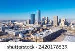 Aerial view downtown Oklahoma City with apartment complex, office buildings, skyscraper business district, residential high-rise condo, urban street under sunny clear blue sky winter time. USA