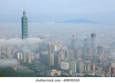 Aerial view of Downtown Taipei, capital city of Taiwan, on a foggy spring morning with prominent Taipei 101 Tower above clouds amid skyscrapers in Xinyi District  Datun Mountain in distant background - Powered by Shutterstock