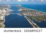 Aerial view of downtown West Palm Beach, Florida, and the upscale island of Palm Beach, with golf courses and Worth Avenue shopping.
