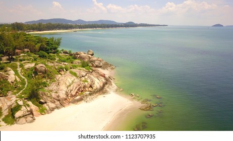 Aerial view of a dramatic coastline with cliffs and rocks on nice day background.