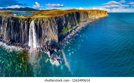 Aerial view of the dramatic coastline at the cliffs by Staffin with the famous Kilt Rock waterfall - Isle of Skye - Scotland. - Powered by Shutterstock