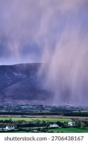 Aerial view of dramatic evening storm clouds at stunning evening in Ireland Co.Mayo, pouring rain beside mountain. High quality photo