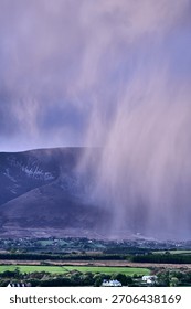 Aerial view of dramatic evening storm clouds at stunning evening in Ireland Co.Mayo, pouring rain beside mountain. High quality photo