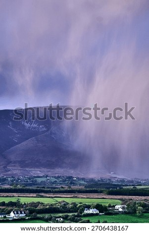 Aerial view of dramatic evening storm clouds at stunning evening in Ireland Co.Mayo, pouring rain beside mountain. High quality photo