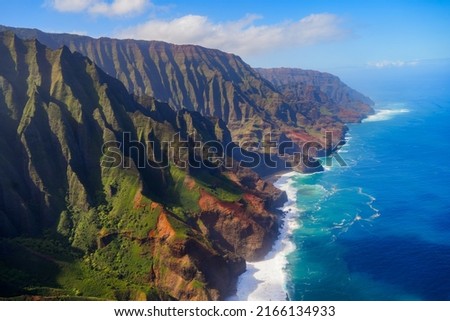 Aerial view of the dramatic ridges of the Na Pali coast, looming over the Pacific Ocean on the northwestern side of Kauai island in Hawaii