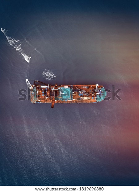 Aerial view of dredger ship in a river.\
Selective focus. Contains noise and\
grains.