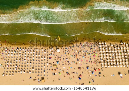 Similar – Luftaufnahme von fliegenden Drohnen von Menschen, die sich am Algarve Beach in Portugal entspannen.