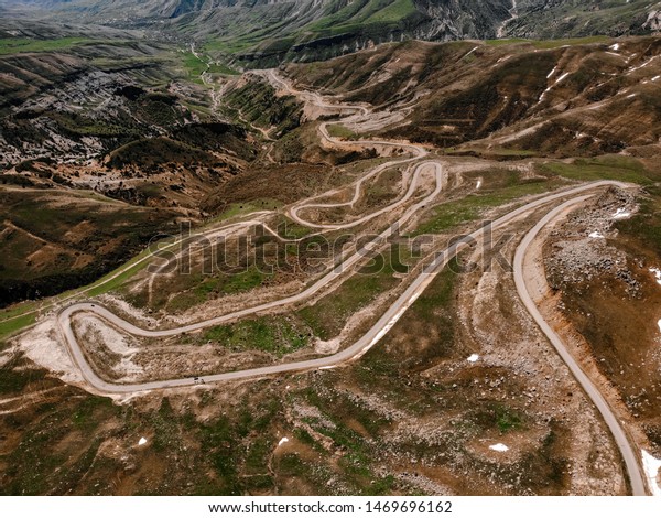 Aerial view of the drone curve of the road on\
the mountain