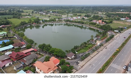 Aerial View From Drone Of Kalasin Park ,a Large Lake Surrounded By Small Parks In Kalasin, Thailand.The Locals Come To Run, Walk, Cycle And Chill Out With The Sunflower Field. 