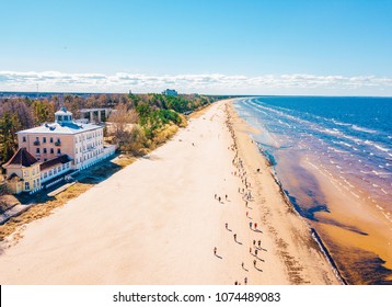 Aerial view from drone on crowd of people who is starting are running on marathon event by the sea shore in Jurmala, Latvia.