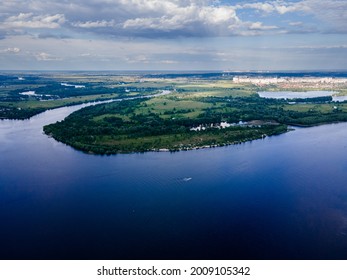 Aerial view from a drone on a fresh river among a green meadow in summer - Shutterstock ID 2009105342