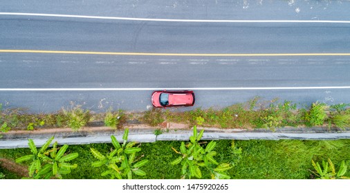 Aerial View Drone Shot Of Red Suv Car On Road.