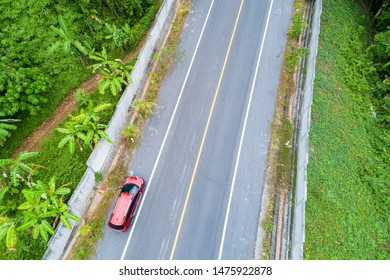 Aerial View Drone Shot Of Red Suv Car On Road.