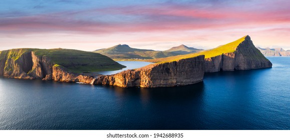 Aerial view from drone of Sorvagsvatn lake on cliffs of Vagar island in sunset time, Faroe Islands, Denmark. Landscape photography panorama