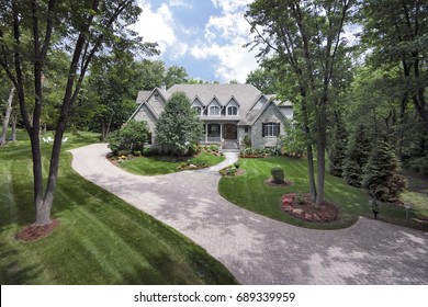 Aerial View With A Drone Of An Upscale Home With Front Porch In A Suburban Setting.