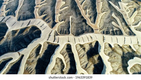 Aerial view of dryland agriculture under the sunlight. Abstract geometric shapes of farm plots. Environnement and global warming
