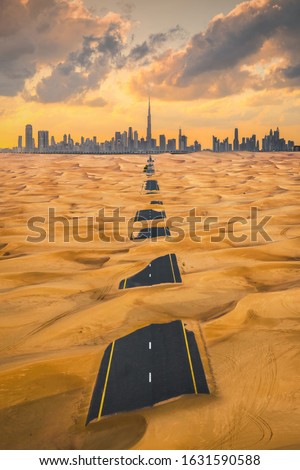 Aerial view of Dubai Downtown skyline with half desert sand road, United Arab Emirates or UAE. Financial district and business area in smart urban city. Skyscraper and high-rise buildings at sunset.