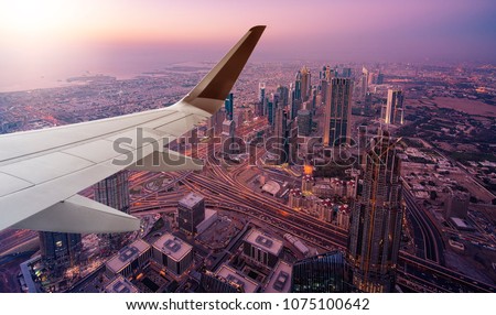 aerial view of Dubai seen from an airplane with wing in front
