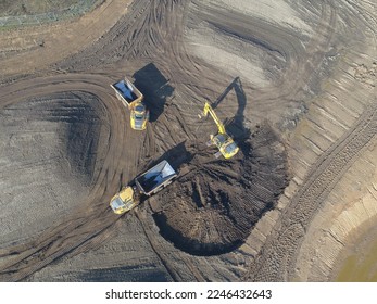 Aerial view of early stage construction on this huge construction site, showing large earth moving equipment. - Powered by Shutterstock