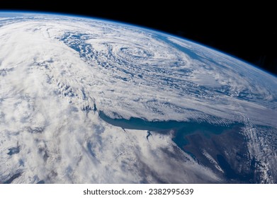 Aerial View of Earth's Atmosphere with Cloud Formations and Oceanic Swirls from Space. Elements of this image furnished by NASA - Powered by Shutterstock