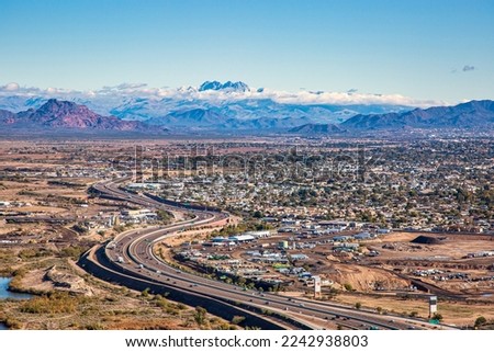 Aerial view of East Mesa, Arizona with Red Mountain, the Superstition Mountains and Four Peaks shrouded in clouds