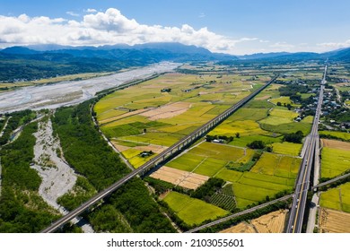 Aerial view of eastern Taiwan landscape. Bird eye of river, yellow paddy, mountain, railway and Taiwan Route 9 in Guanshan Township, Taitung country, Taiwan, Asia