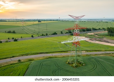 Aerial view of electric power transmission lines at sunset