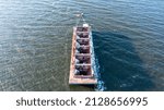 An aerial view of an empty barge in Hempstead Bay, NY on a cold winter evening. It was taken with a drone showing a lack of activity and no people.