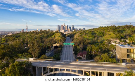 Aerial view of empty freeway streets with no people in downtown Los Angeles California as result of  coronavirus pandemic or COVID-19 virus outbreak and lockdown.