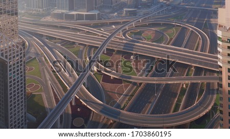 Aerial view of empty highway interchange in Dubai downtown after epidemic lockdown. Cityscapes with disappearing traffic on a bridge and streets. Roads and lanes crossroads without cars, Dubai, United