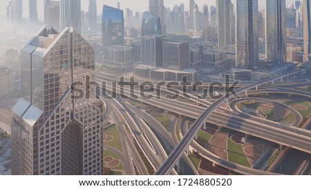 Aerial view of empty highway interchange in Dubai downtown after epidemic lockdown. Cityscapes with disappearing traffic on a bridge and streets. Roads and lanes crossroads without cars, Dubai, United