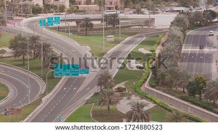 Aerial view of empty highway and interchange in Dubai after epidemic lockdown. Cityscapes with disappearing traffic on streets. Roads and lanes crossroads without cars near JLT, Dubai, United Arab