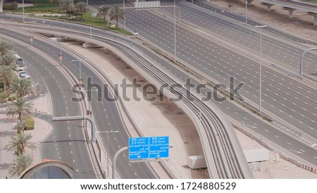 Aerial view of empty highway and interchange in Dubai after epidemic lockdown. Cityscapes with disappearing traffic on streets. Roads and lanes crossroads without cars, Dubai, United Arab Emirates