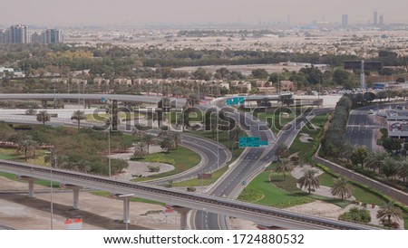 Aerial view of empty highway and interchange in Dubai after epidemic lockdown. Cityscapes with disappearing traffic on streets. Roads and lanes crossroads without cars near JLT, Dubai, United Arab