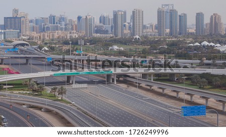 Aerial view of empty highway and interchange in Dubai after epidemic lockdown. Cityscapes with disappearing traffic on streets. Roads and lanes crossroads without cars near golf course, Dubai, United