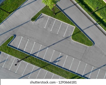 Aerial View Of Empty Parking Lot  With Grass Isles