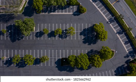 Aerial View Of An Empty Shopping Center Parking Lot, Emptied Due To Businesses Closing For Shelter At Home Orders Because Of COVID-19.