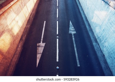 Aerial view of empty two lane road with opposite direction arrows - Shutterstock ID 593283926