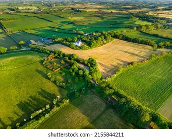 Aerial view of endless lush pastures and farmlands of Ireland. Beautiful Irish countryside with emerald green fields and meadows. Rural landscape. - Powered by Shutterstock