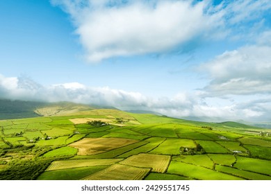 Aerial view of endless lush pastures and farmlands of Ireland's Dingle Peninsula. Beautiful Irish countryside with emerald green fields and meadows. Rural landscape on sunset. - Powered by Shutterstock