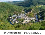 Aerial view of Esch-sur-Sure medieval town in Luxembourg  famous for its ancient  Castle. Forests of Upper-Sure Nature Park, meander of winding river Sauer, near Upper Sauer Lake. Canton Wiltz. 