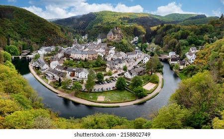 Aerial view of Esch-sur-Sure, medieval town in Luxembourg, dominated by castle, canton Wiltz in Diekirch. Forests of Upper-Sure Nature Park, meander of winding river Sauer, near Upper Sauer Lake. - Shutterstock ID 2158802749