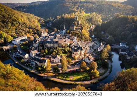 Aerial view of Esch-sur-Sure, medieval town in Luxembourg, dominated by castle, canton Wiltz in Diekirch. Forests of Upper-Sure Nature Park, meander of winding river Sauer, near Upper Sauer Lake.
