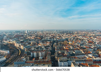 Aerial View Of European City Skyline With Railroad Curve And Buildings To Horizon, Under Blue Sky In Sunny Day