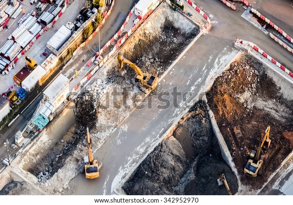 Aerial view excavators and tipper trucks working at\
construction. Hong Kong