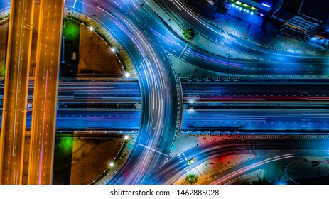 Aerial View Expressway Motorway Highway Circus Intersection At Night Time Top View , Road Traffic In City At Thailand.