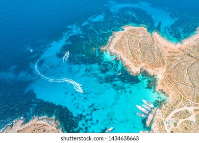 Aerial view famous Blue Lagoon in the Mediterranean Sea  Comino Island  Malta  Beach   vacationers  bay pier and ships   boats