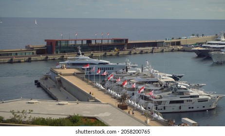 Aerial View Of The Famous City On The Mediterranean Sea Luxury Yacht Moored In The Bay, Marina Port, Yacht Club. Panorama Of The European Landscape From Above MONTE CARLO, MONACO SEPTEMBER 2021 